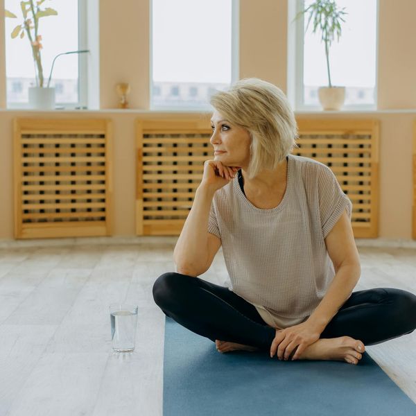 Person sitting peacefully after a workout session, looking relaxed.